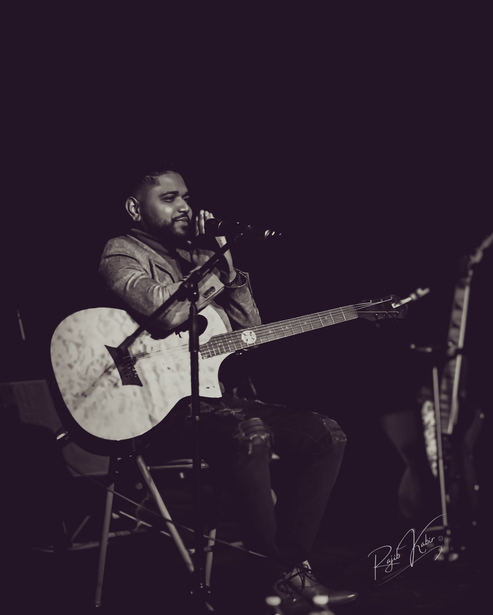 A live concert moment capturing a guitarist immersed in performance.