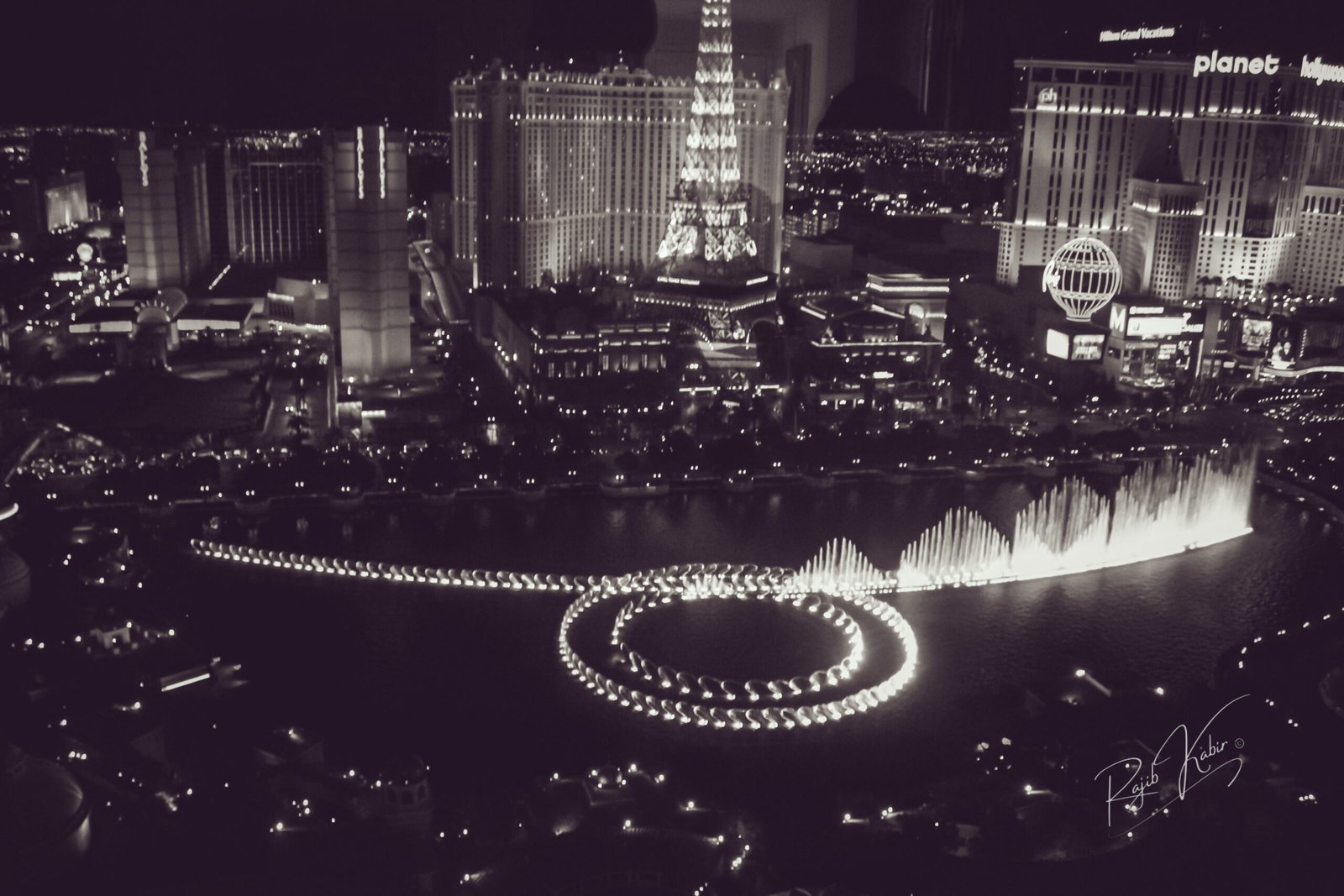 A stunning aerial view of the Bellagio Fountains in Las Vegas at night, captured in black and white by Rajib Kabir