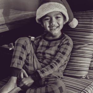 Ayyash in a Santa hat, smiling with pure joy.