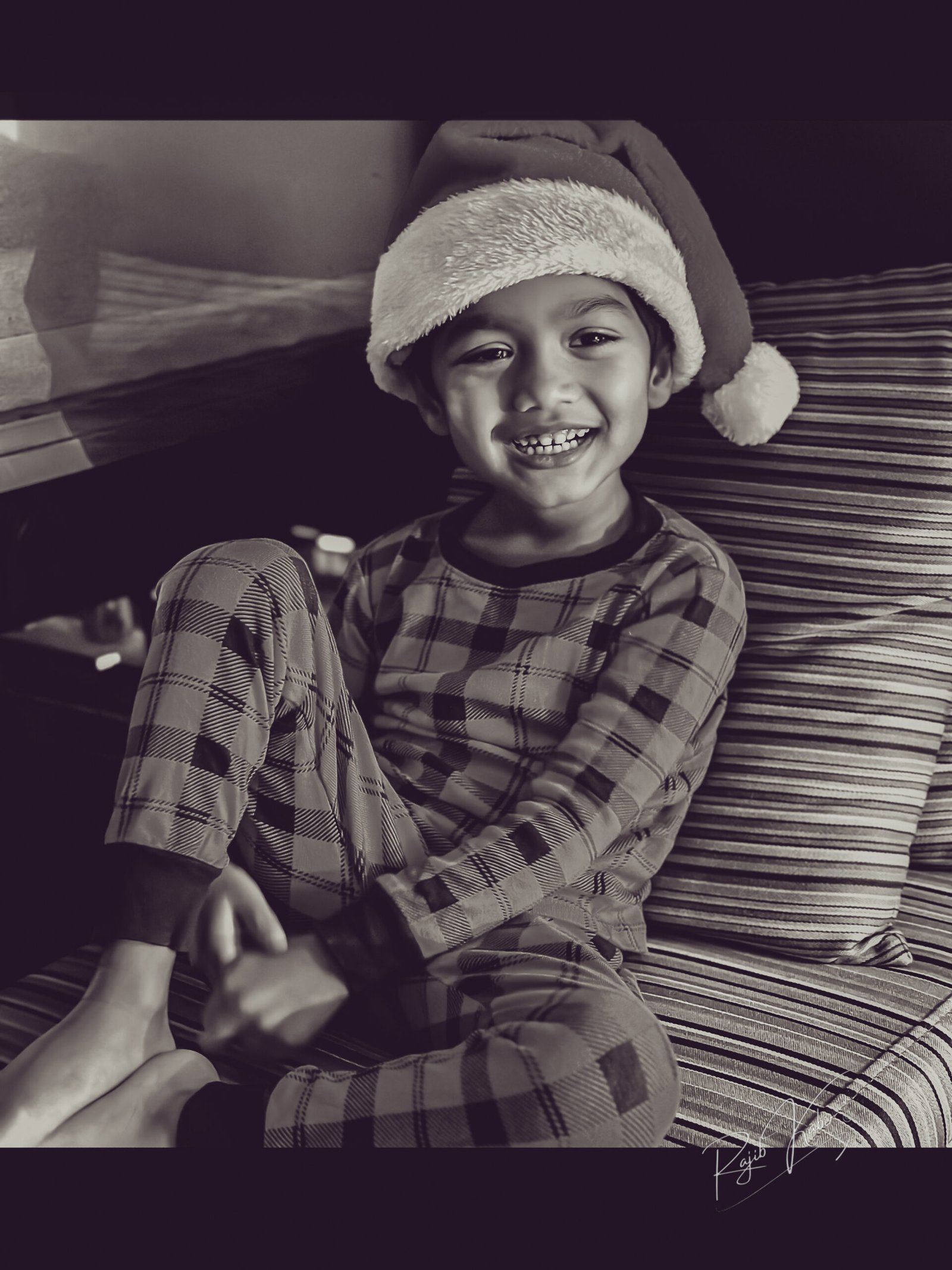 Ayyash in a Santa hat, smiling with pure joy.